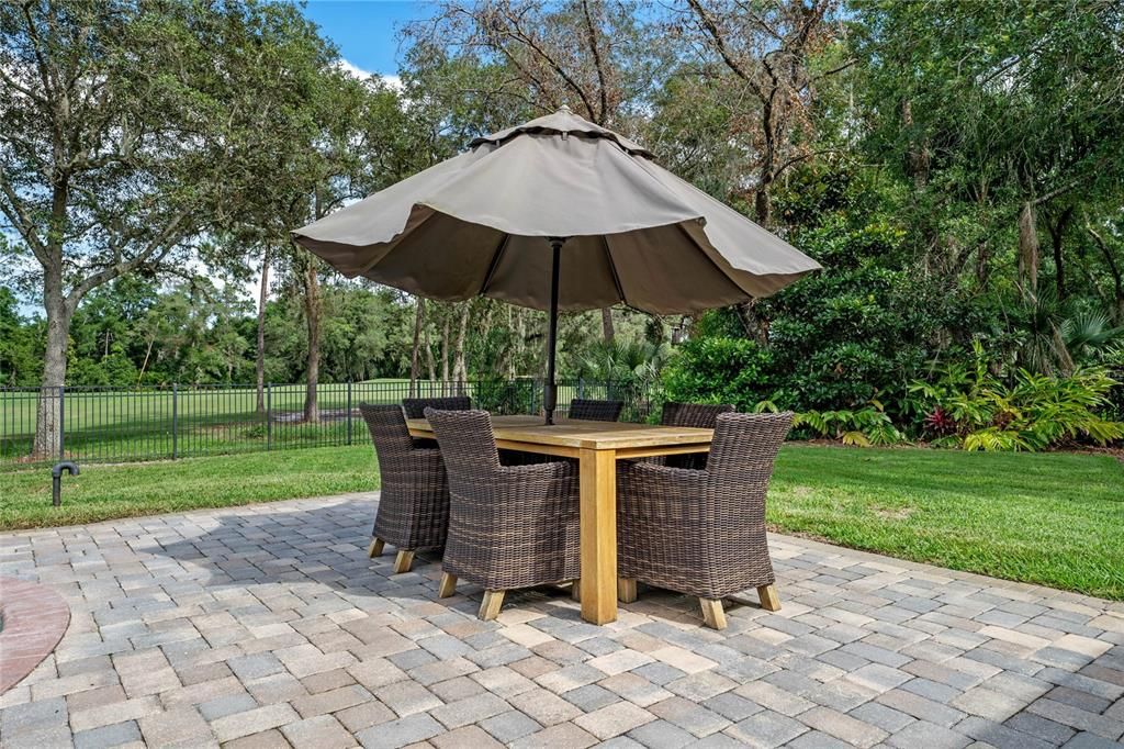 The outdoor dining area is ideal for alfresco meals with a picturesque view.