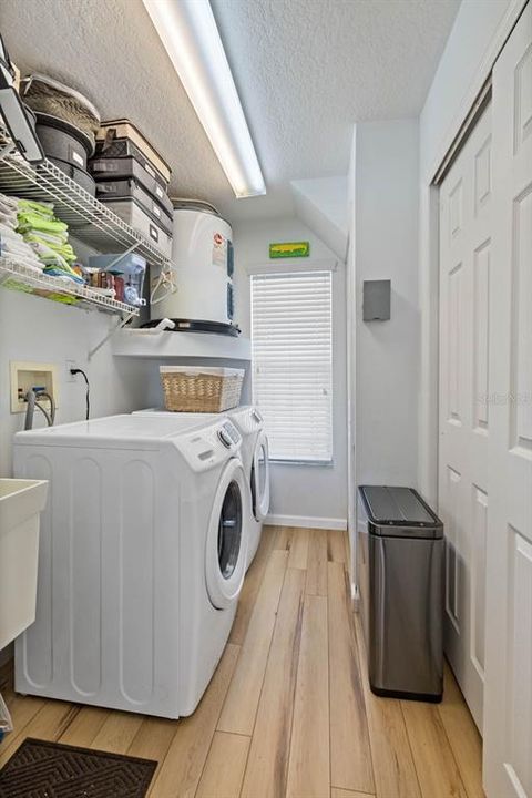 Laundry room with linen storage.