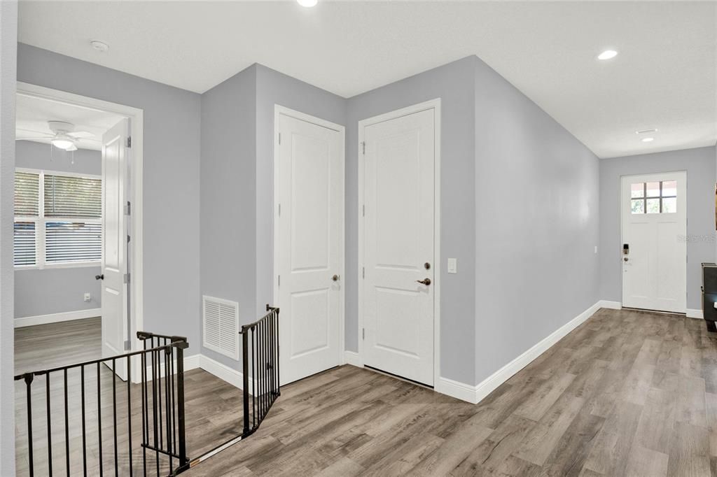 Foyer to Front Door and Cove to Bedroom 4 (and showing garage entry door)