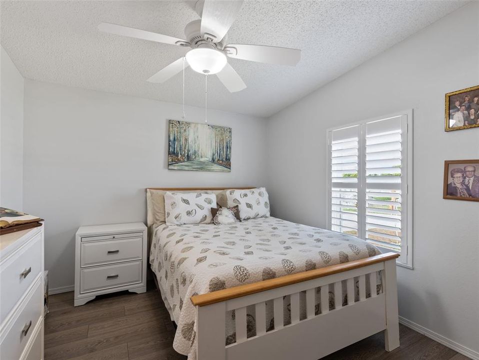 Guest bedroom with plantation shutters and LVP floors