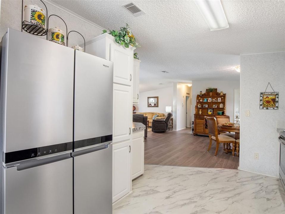 Upgraded Stainless Refrigerator in this sleek kitchen OPEN to dining area