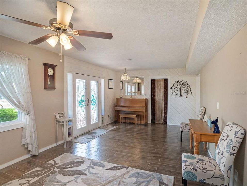 Living Room - Light-filled haven with high ceilings and ceramic tile floors.