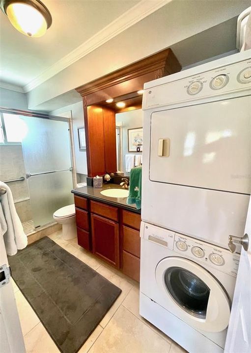 Bathroom includes glass enclosed walk-in shower, washer & dryer.