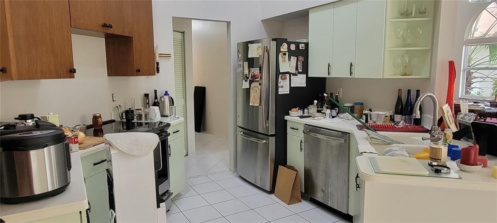 Kitchen is just to the right of the living room. Laundry is just beyond the Kitchen in the hallway