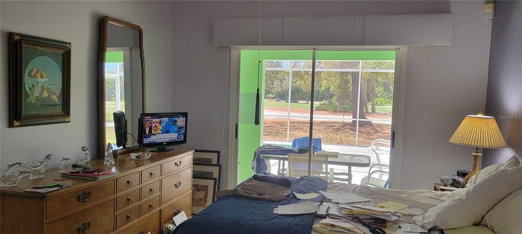 Primary bedroom also opens to the lanai and pool