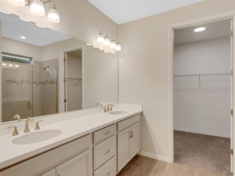 En suite bath with Dual Vanity and walk-in closet