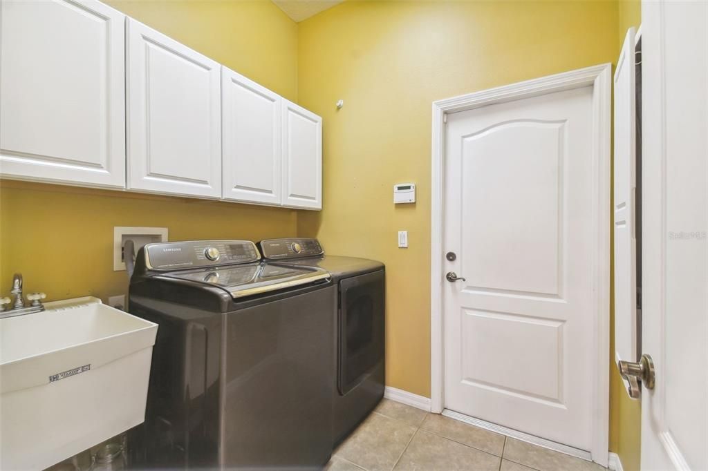 Large laundry room area leading to the garage.