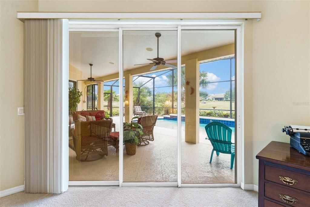 Primary Suite with Sliding Doors leading to Lanai and Pool Area