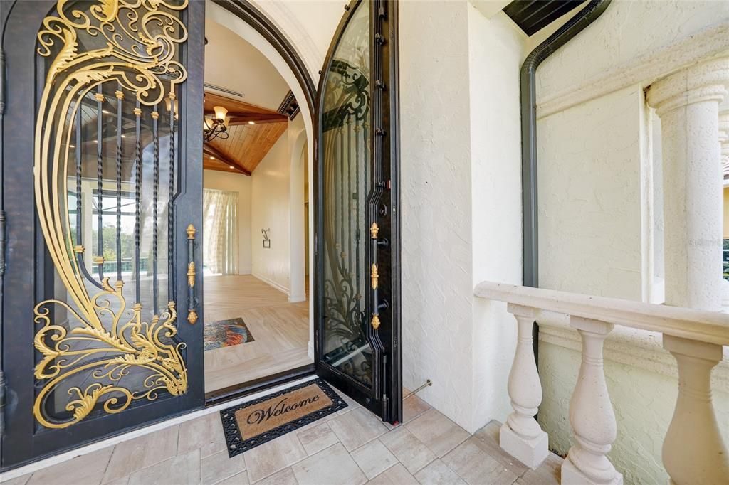 Open the hand-made wrought iron double doors into the custom foyer at 5000 Palermo.