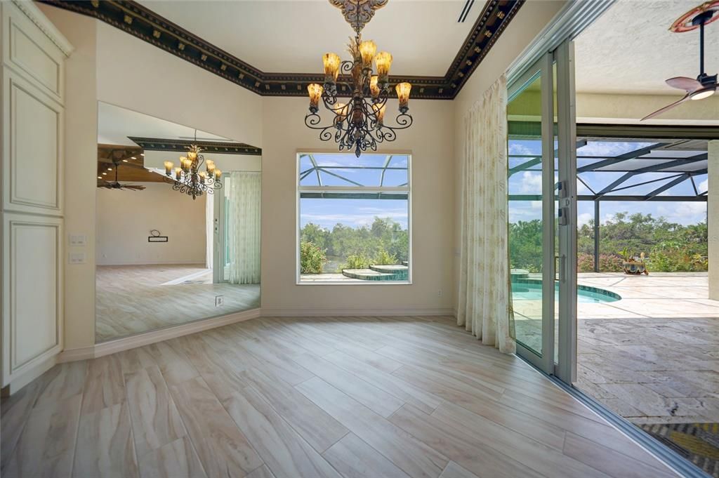 The view to the dining room and tiled outdoors space from the kitchen.