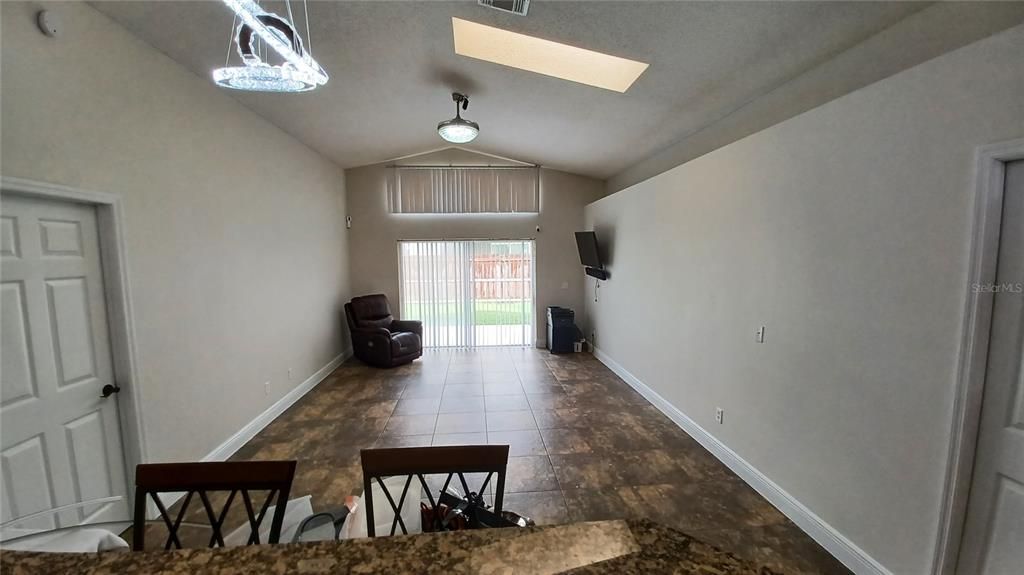 View of Great Room, Skylight, Sliding Door to Patio and Crystal Chandelier Fan.