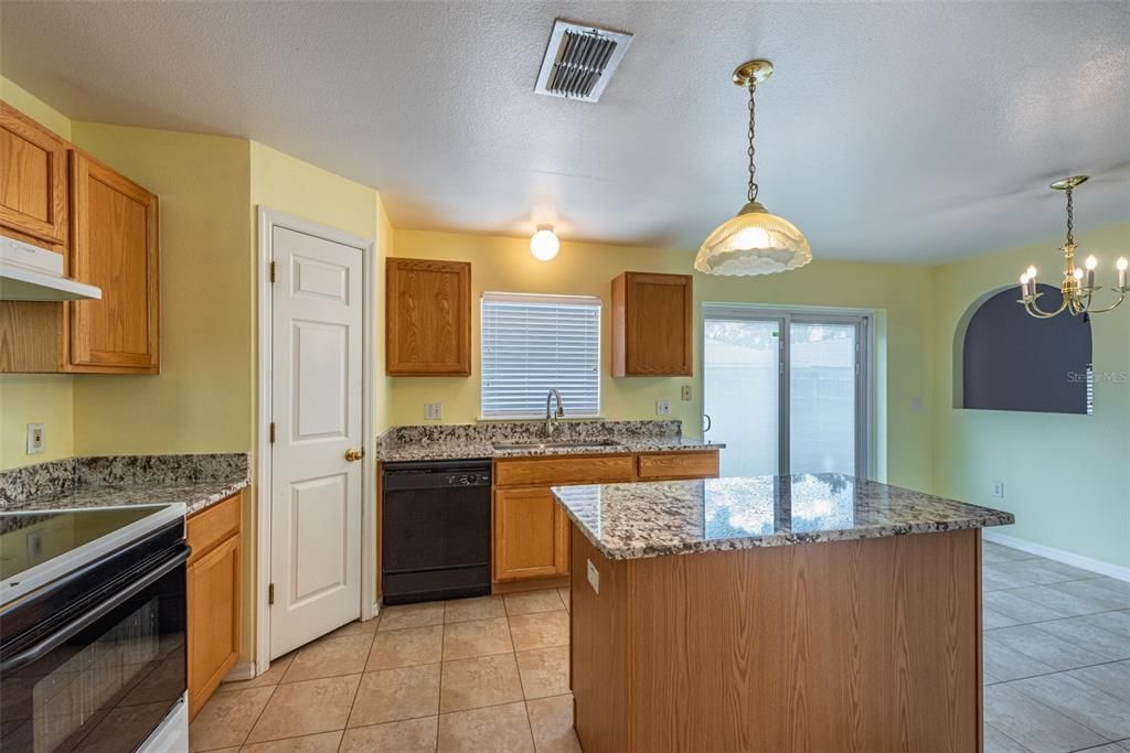 This spacious kitchen has large format tile and a 12x7 dinette area for casual dining.
