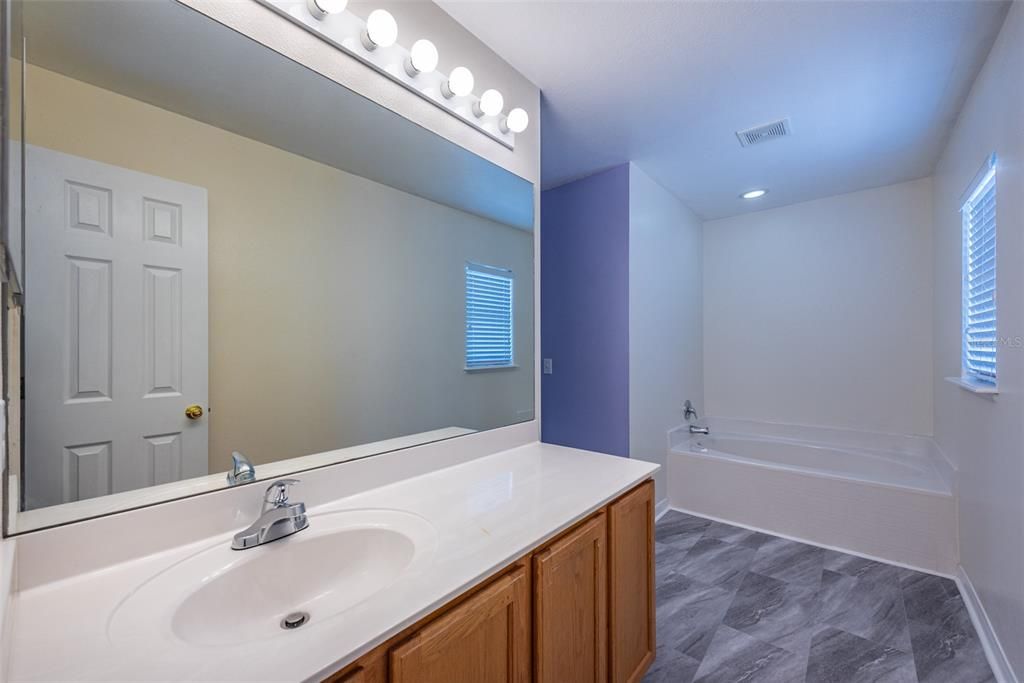 The Primary bathroom has 1 sink, plenty of vanity space and a large soaking tub that is separate from the shower.
