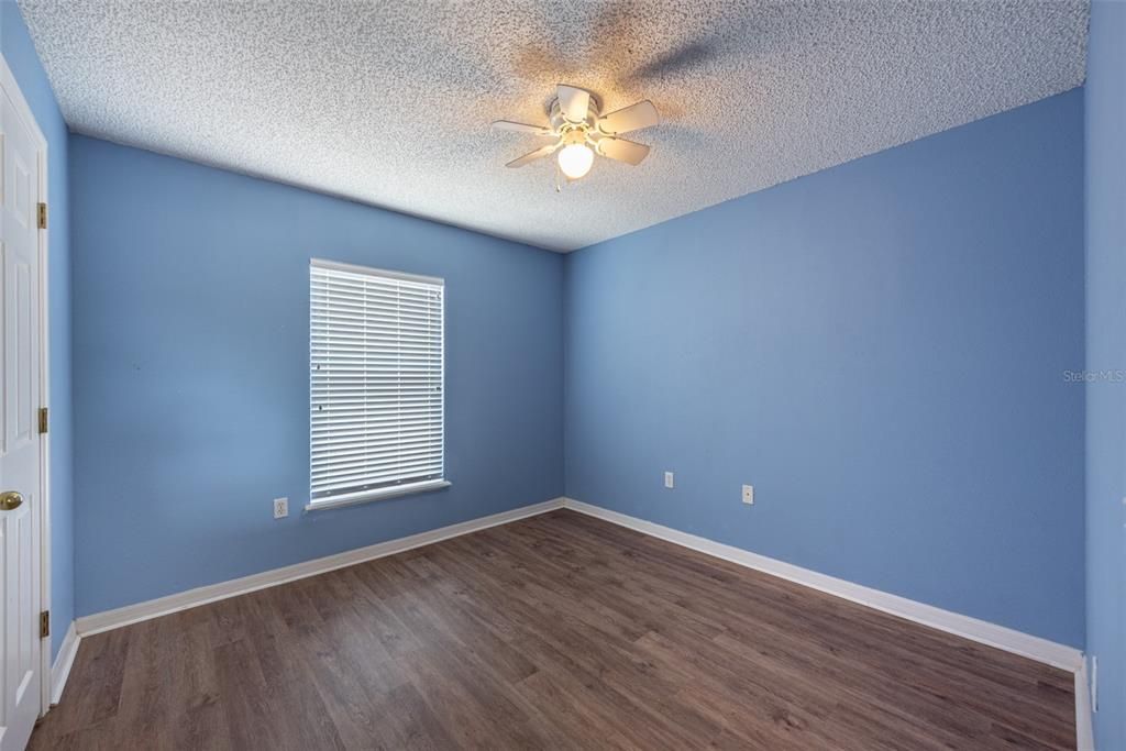 Bedroom #2 is 9' x 5' with ceiling fan, standard built-in closet and luxury vinyl flooring.