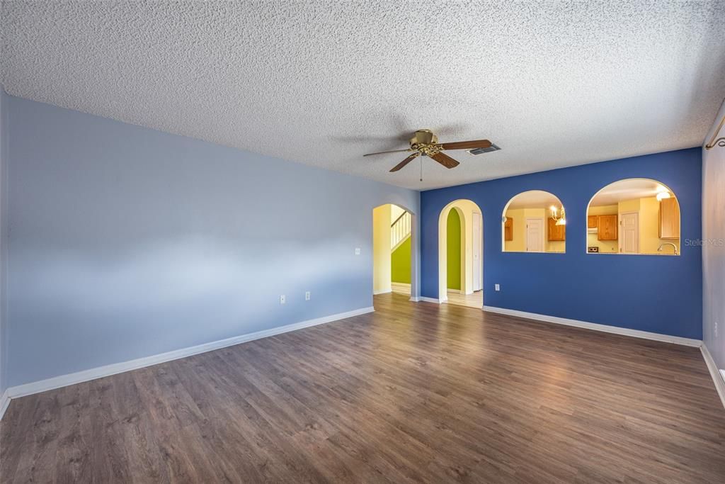 The Living room is next to the kitchen with pass through arched windows and is 19' x 13'.