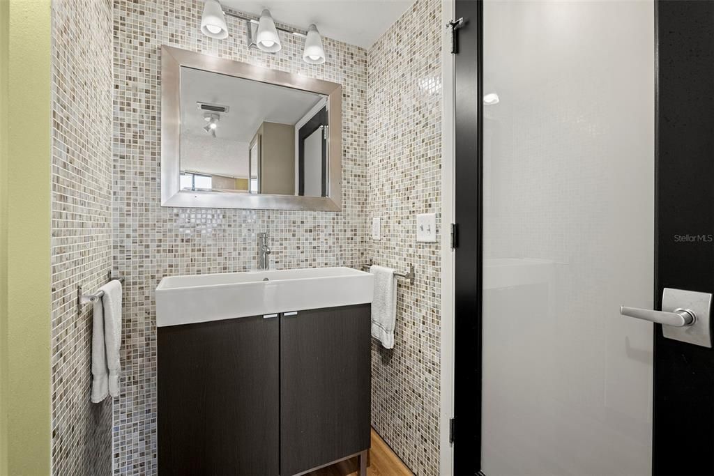 Glass tile throughout the bathrooms