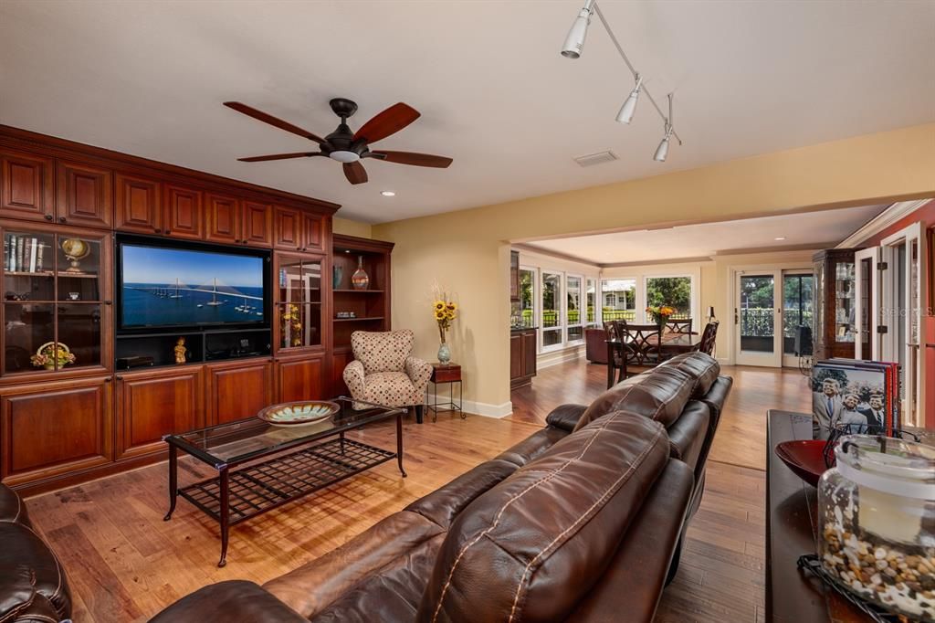 LIVING AREA LEADS TO FAMILY ROOM AREA WITH FLOOR TO CEILING WINDOWS.