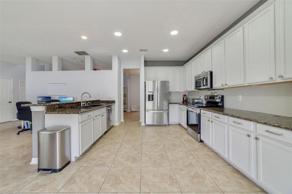Spacious kitchen with granite and stainless steel appliances
