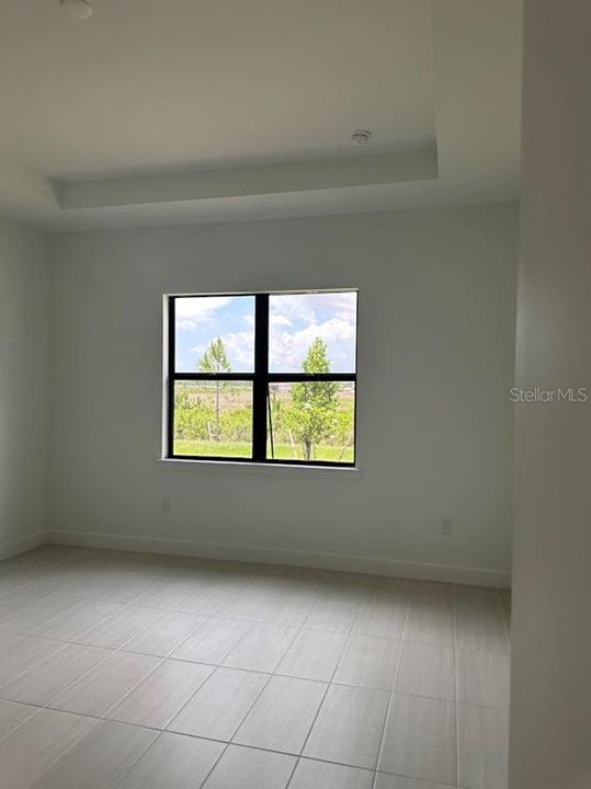 Master bedroom with tray ceiling.  Located near back of home for added privacy.