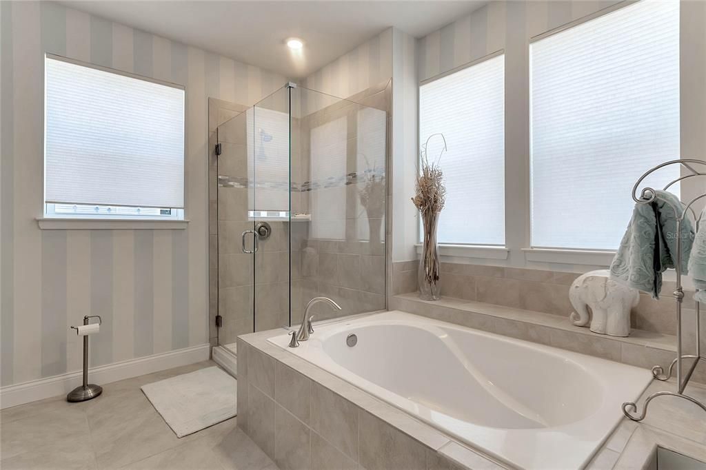 Soak in the tub under another set of windows, or if you prefer there is a separate shower behind seamless glass doors and an extended dual sink vanity gives you plenty of storage!