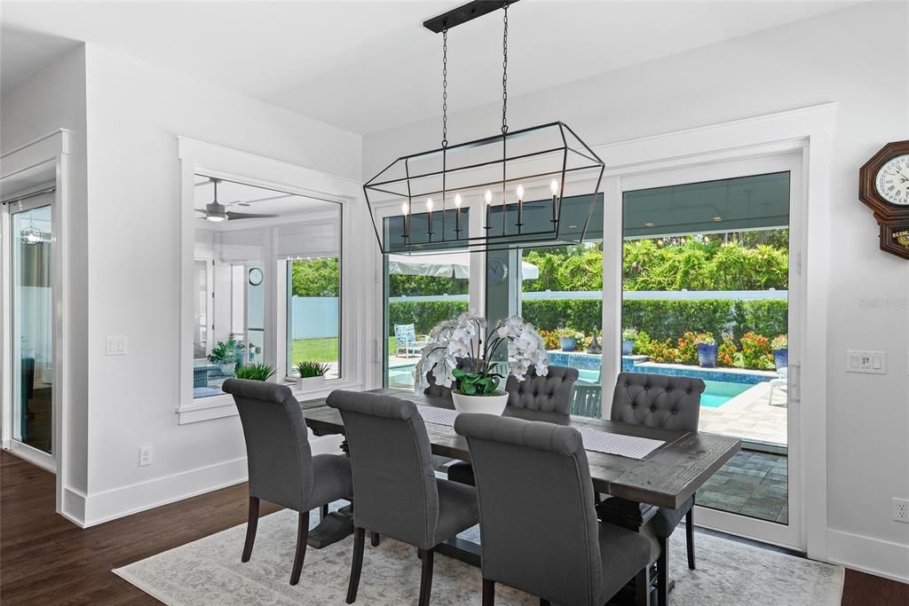 The dining area overlooks the lush and green backyard