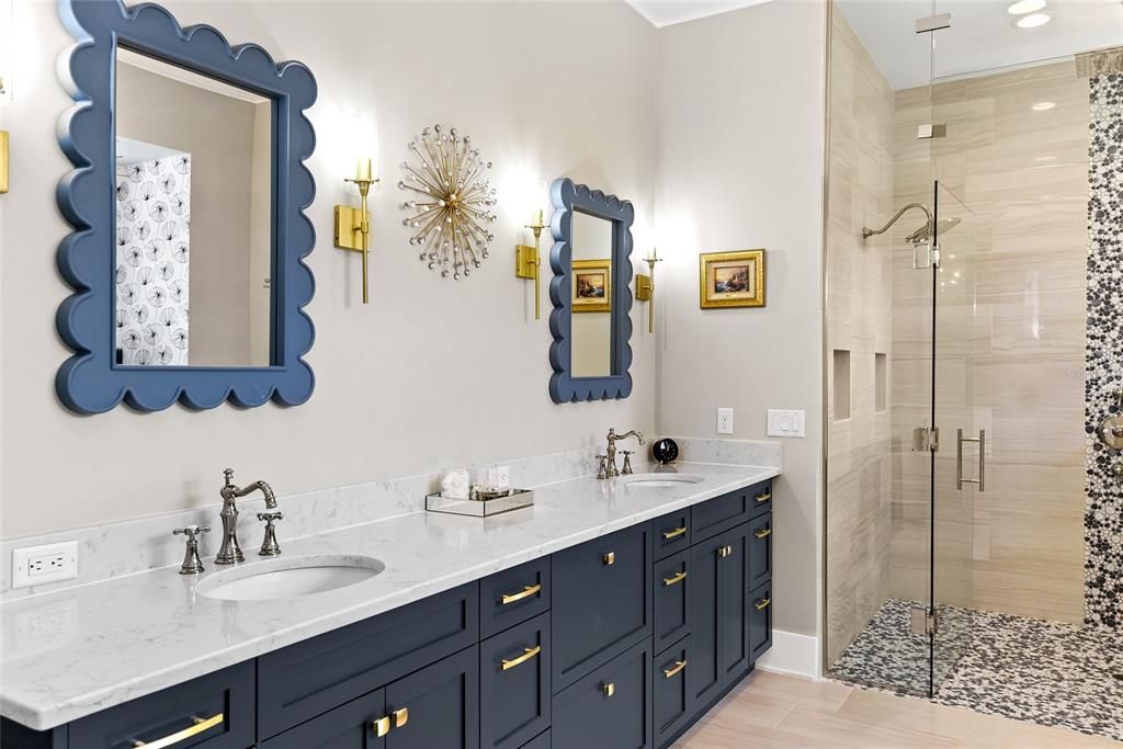 This bath features a large walk-in shower with custom tile and bulit-in bench