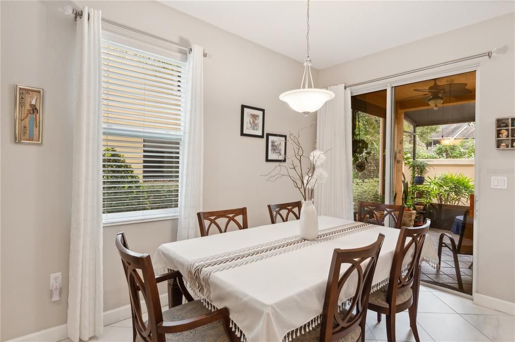 Dining room area with sliding door onto screened room lanai.