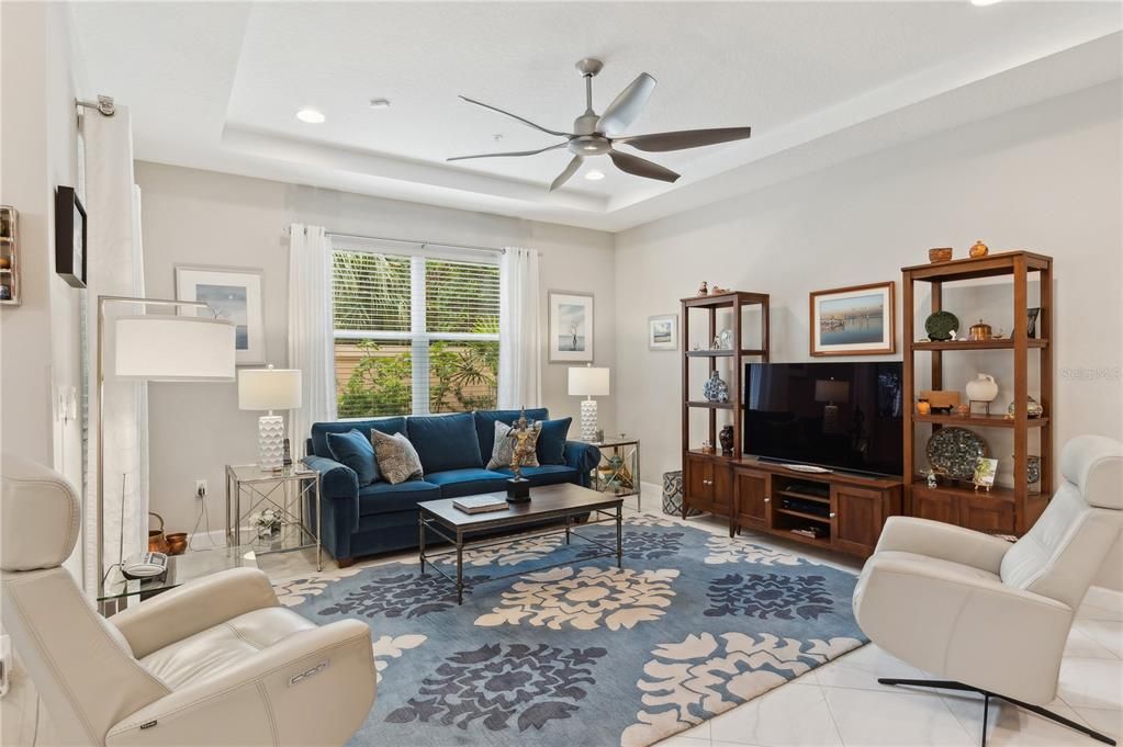 Light and bright living room with beautiful marble tile throughout downstairs