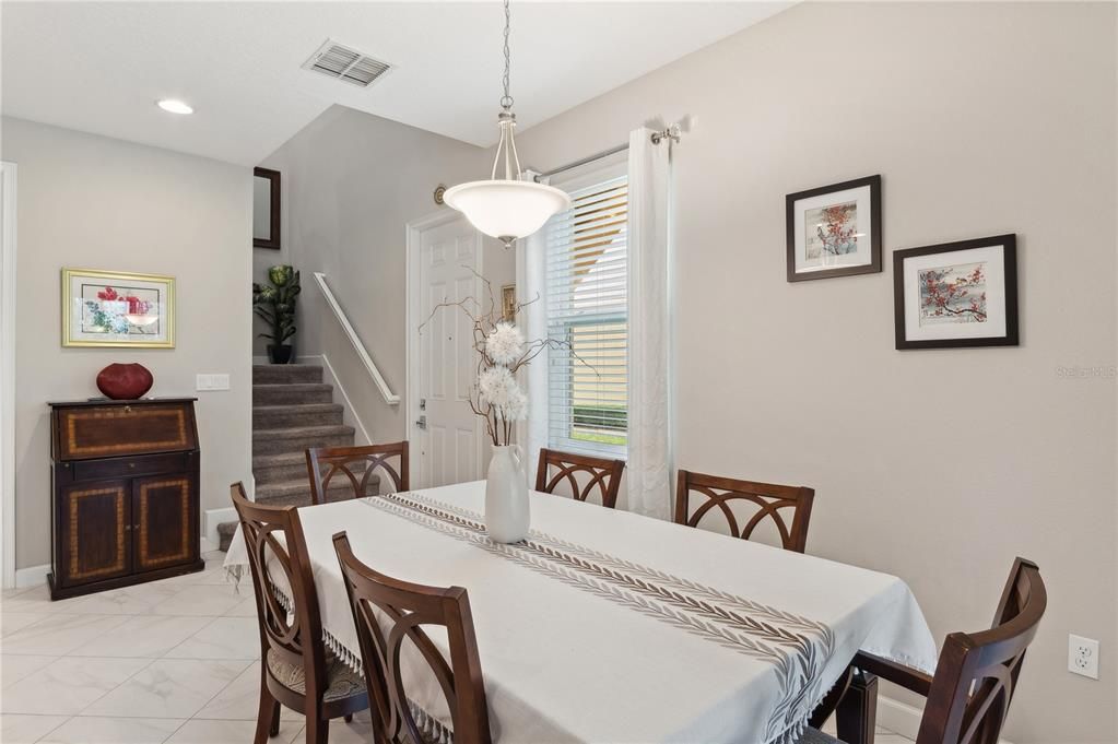 Dining area with door and stairway to second floor & bedrooms