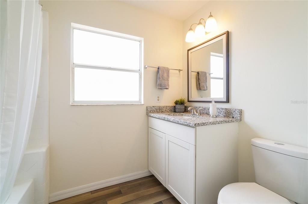 other full bathroom that has single sink vanity area