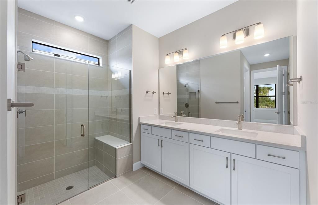 Master bath with walk-in shower & dual sinks.