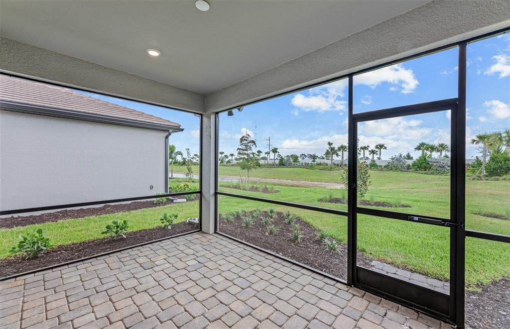 Covered lanai with screen. Room for pool.