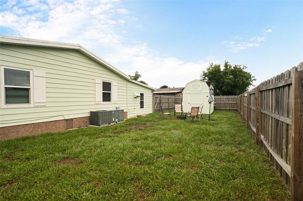 Privacy fenced yard with additional storage shed