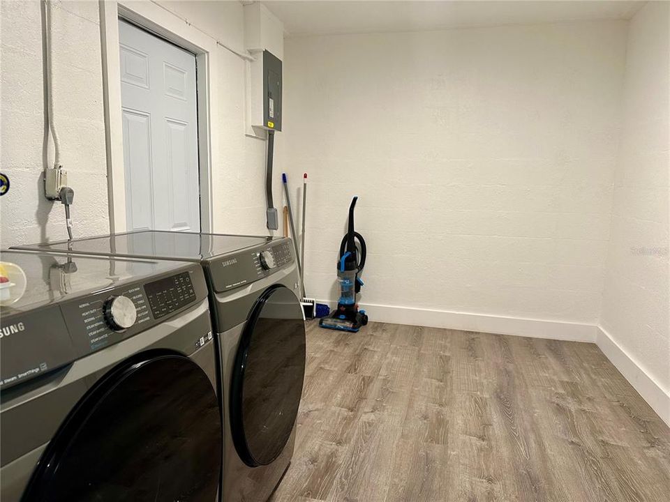 Spacious indoor laundry room with access to backyard