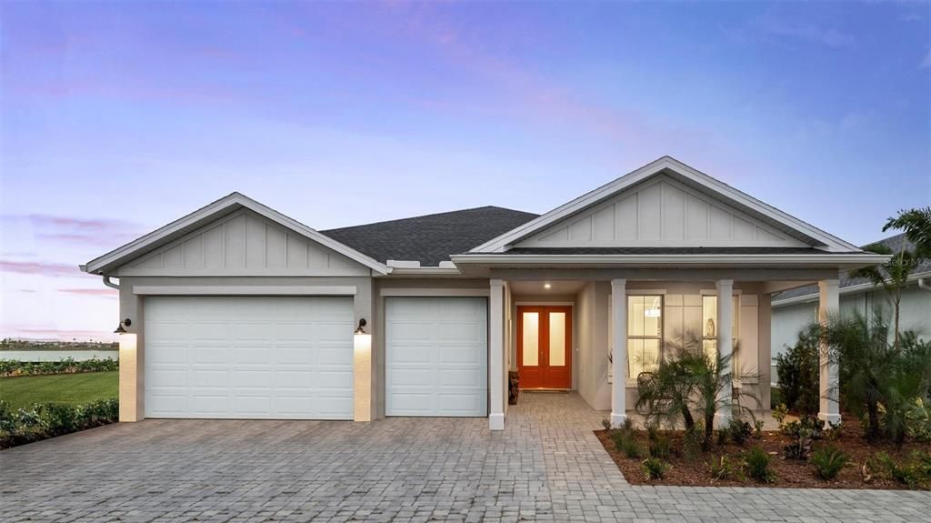 Welcome home! Beautiful Tamiami Farmhouse model home with gorgeous backyard, water view of Lake Babcock-- Three-car garage and double front door entry with a lovely, covered front porch