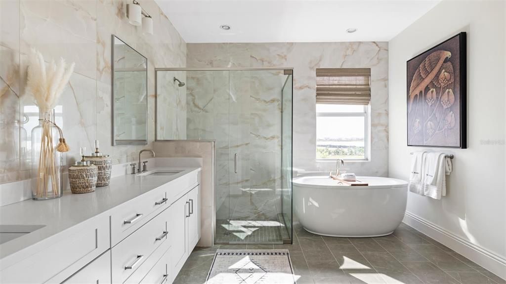 Enter inside your spa-like primary bathroom with luxe shower and free-standing Kohler soaking tub