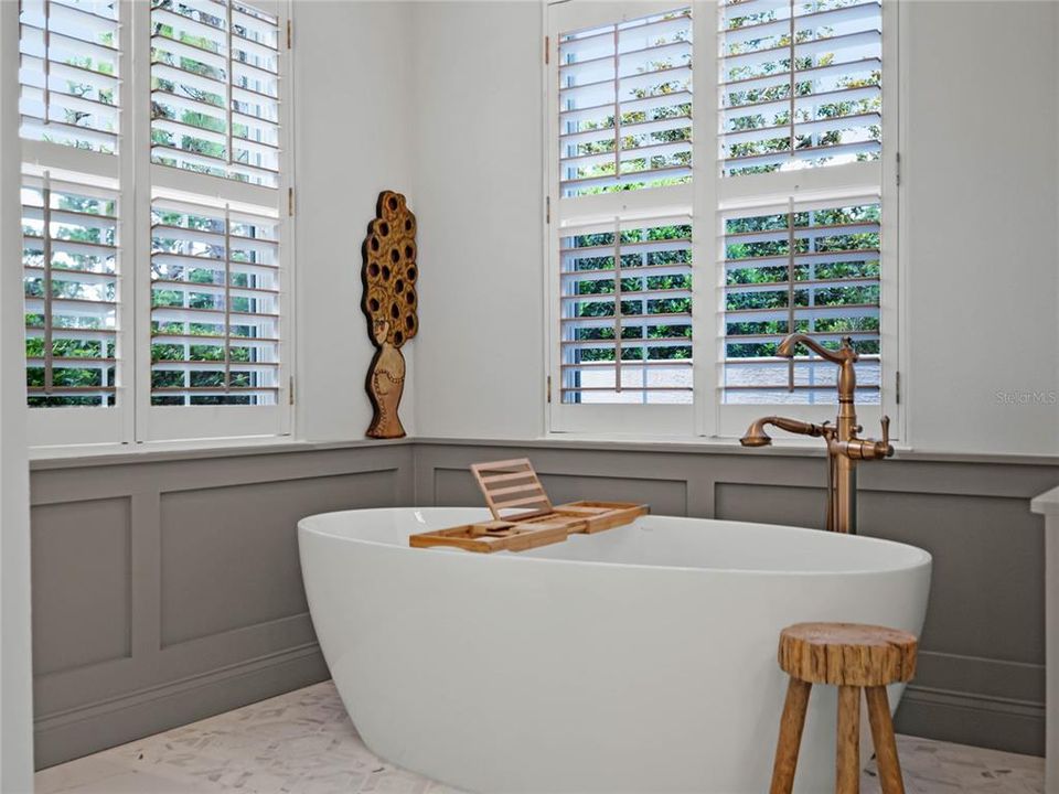 stand-alone tub with a designer chandelier