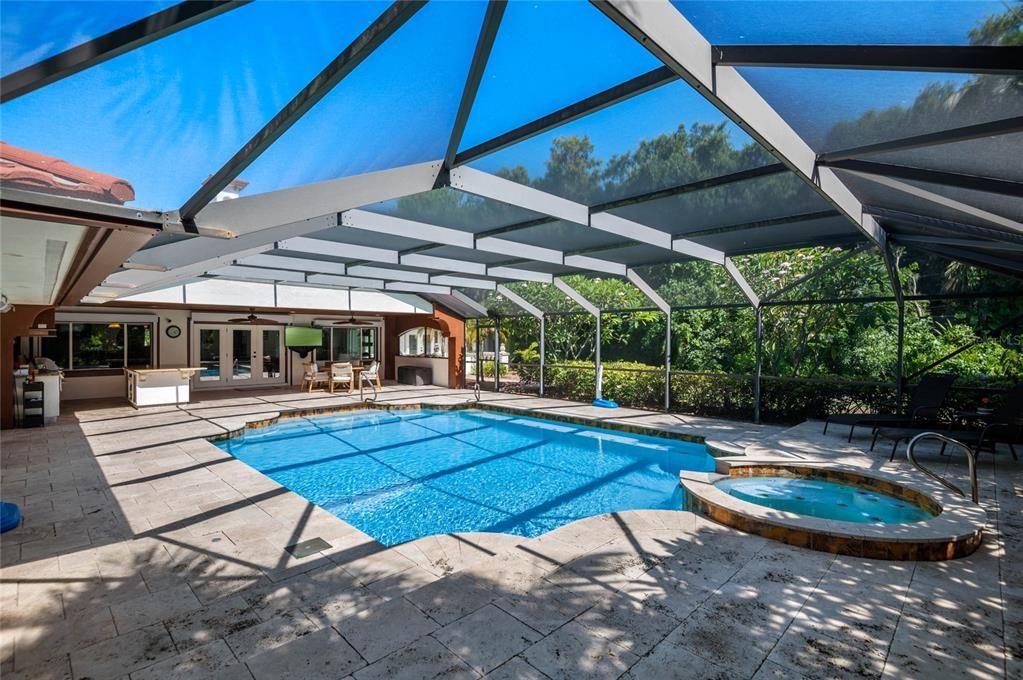 Enjoy the sunny days and starry nights in this spacious, screened pool area, perfect for relaxing or entertaining guests.  Pool and spa are both heated and temperature can be controlled from your phone.