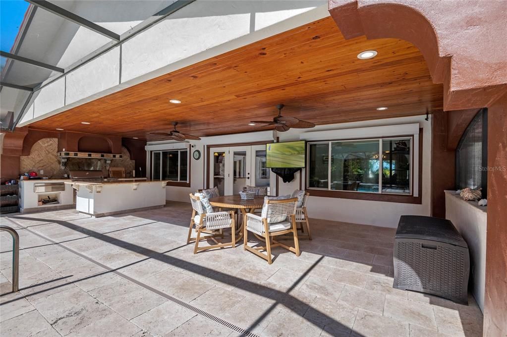 Experience the ultimate outdoor living with a spacious, covered patio complete with a built-in grill and ample seating for entertaining guests.