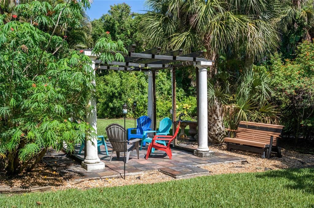 Unwind in the garden pergola, a serene outdoor space perfect for gathering with friends or enjoying a quiet moment surrounded by nature.