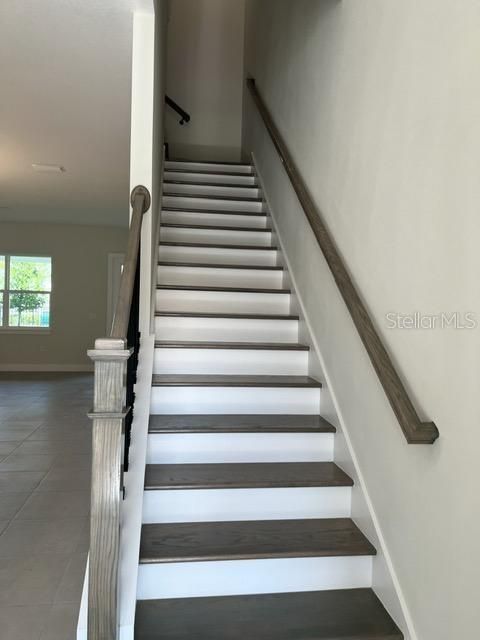 Wood stairs with wrought iron rails