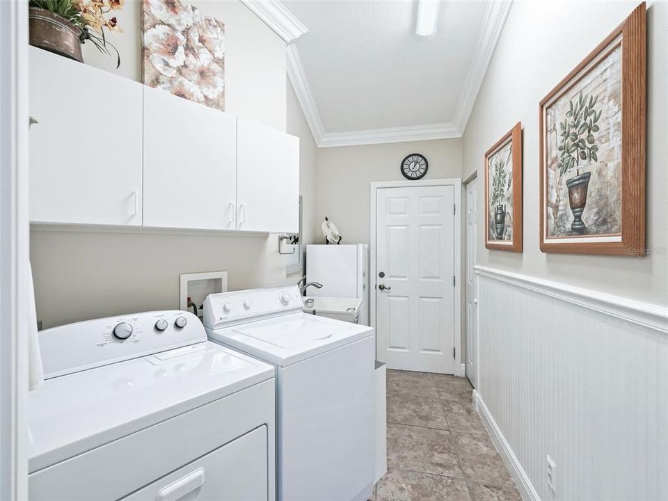 Laundry Room with @ storage closets exit to garage