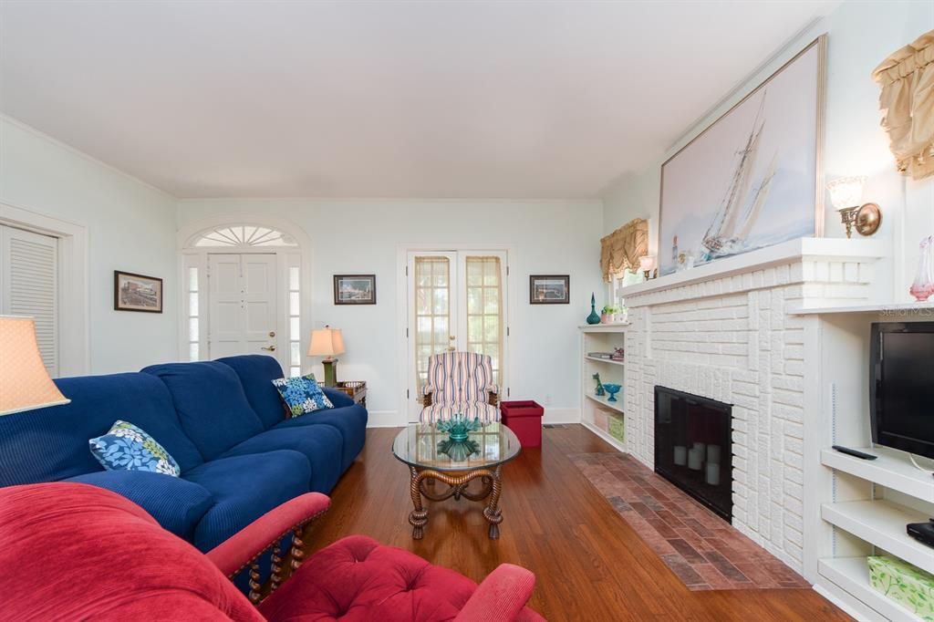 Living room with entry door and porch, French door in back ground