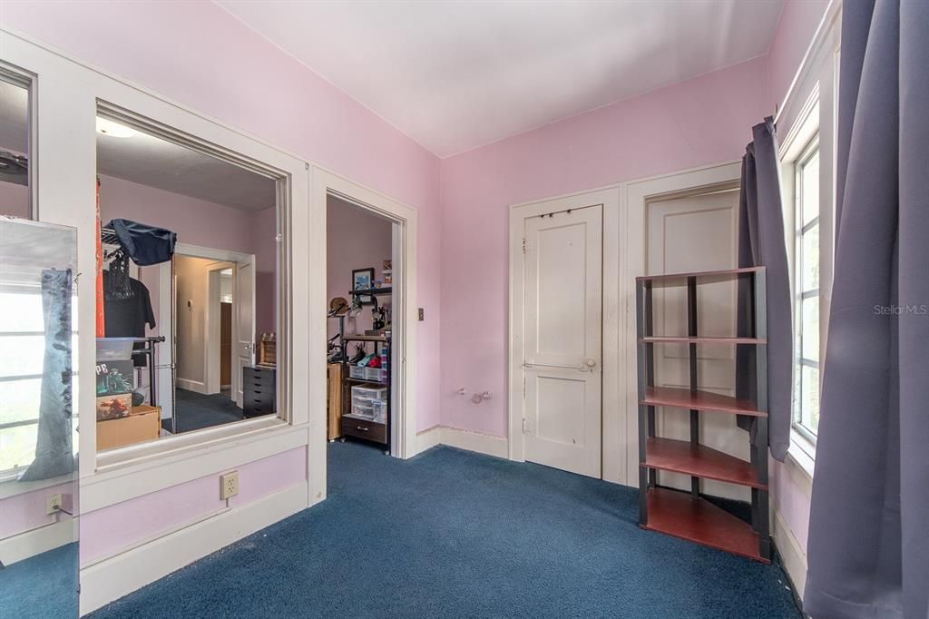 upper back bedroom looking towards middle bedroom with closet and private entrance on right side