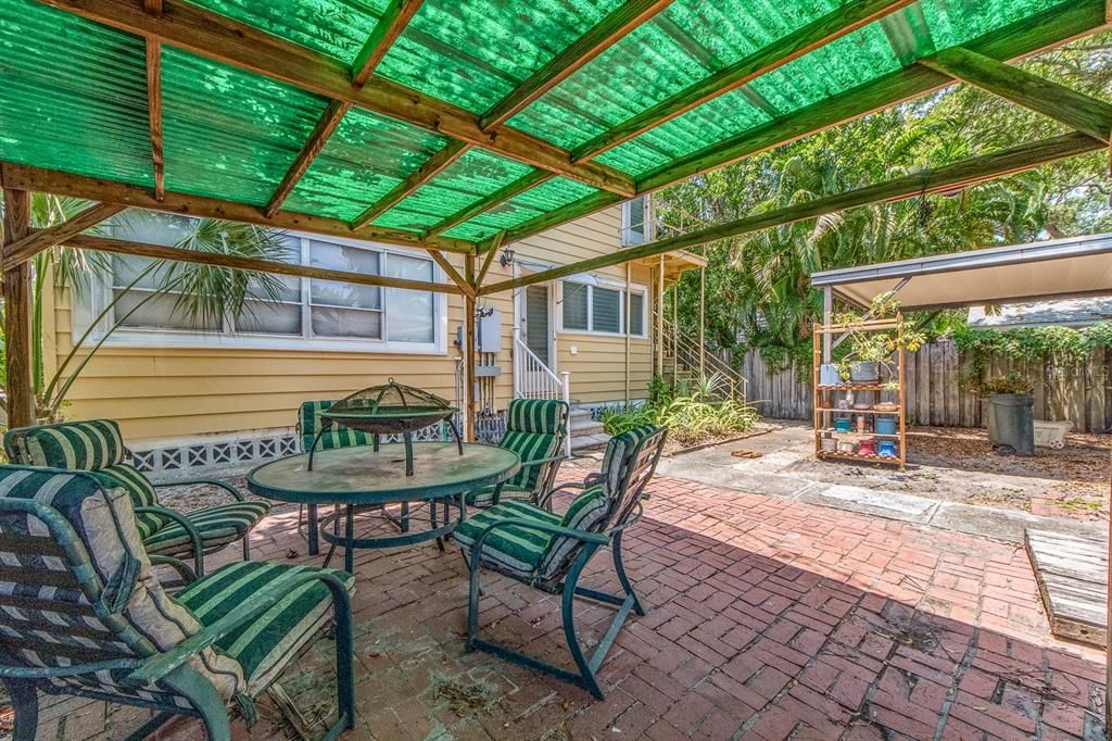 entertaining area with carport in back ground