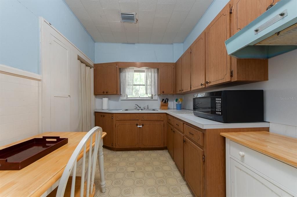 Upper kitchen area includes full size fridge