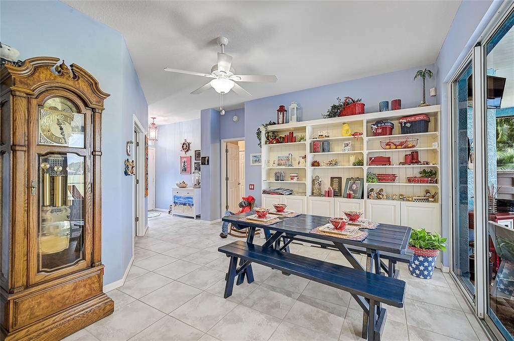 Looking toward entrance foyer - French door to the left opens to a spacious office; to the right is the door to the Master Suite. Sliders on far right open to caged lanai and pool.