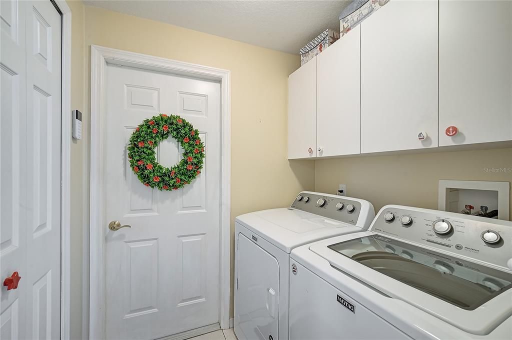 Laundry room, door goes to a spacious 2 car garage with a huge storage room