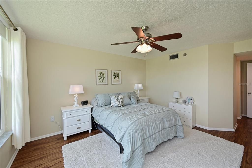 Master bedroom captures a golf course view.