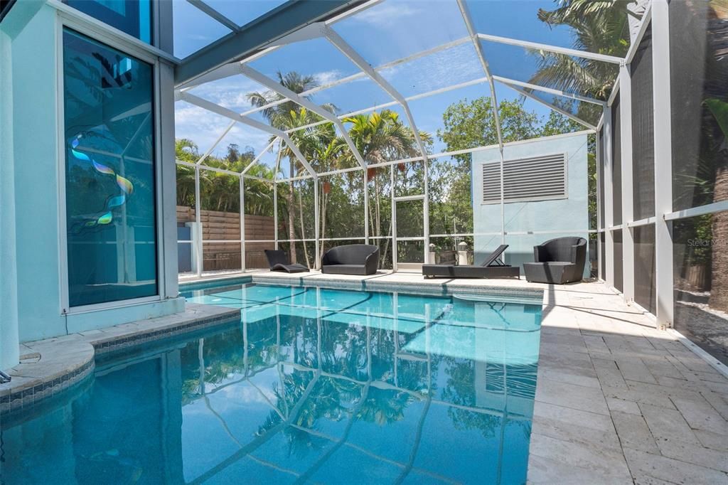 The first level features an indoor/outdoor swimming pool and spa, screened-in lounge area and full outdoor kitchen with stainless appliances and gas range making it the perfect place for family fun and entertaining.
